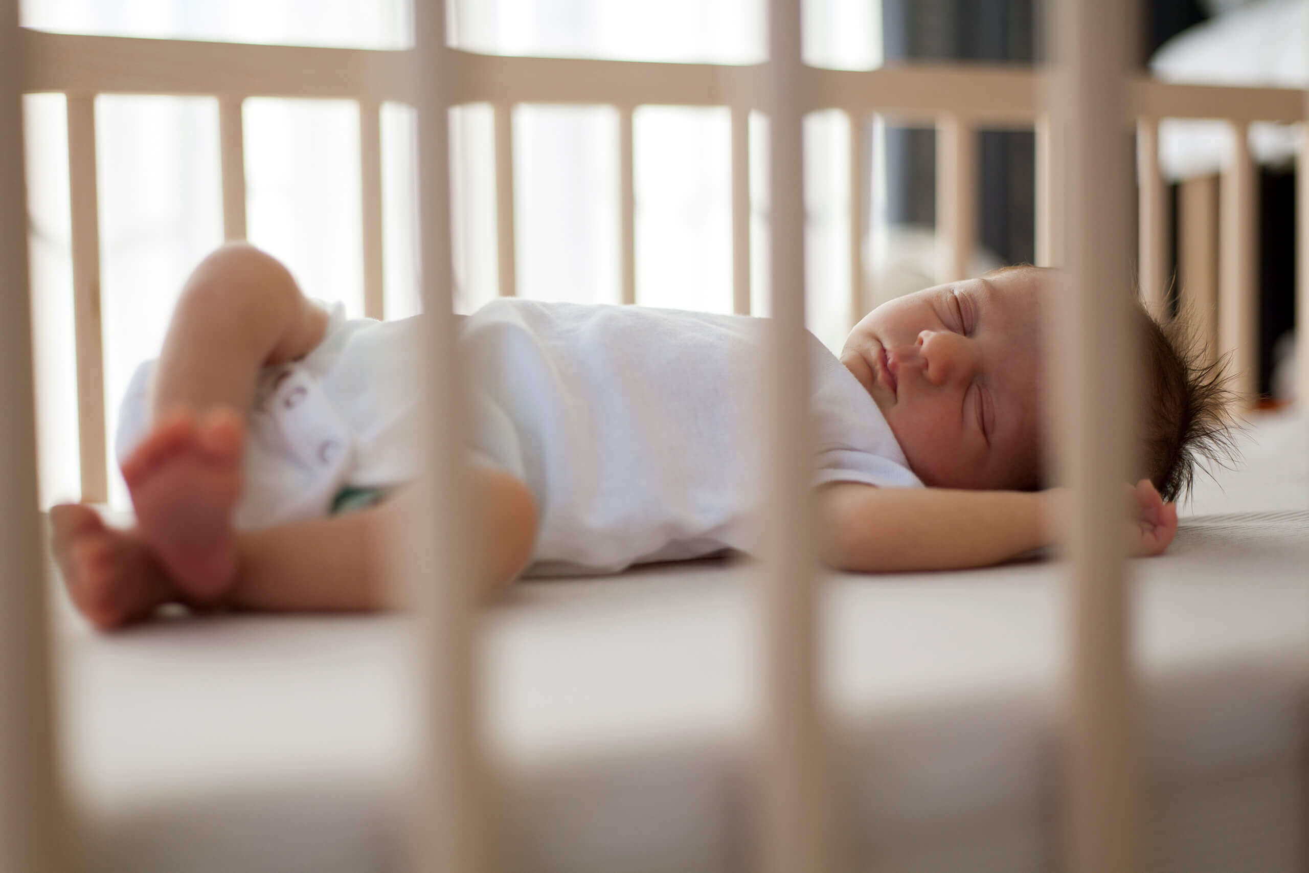 Showing a newborn baby in a crib.